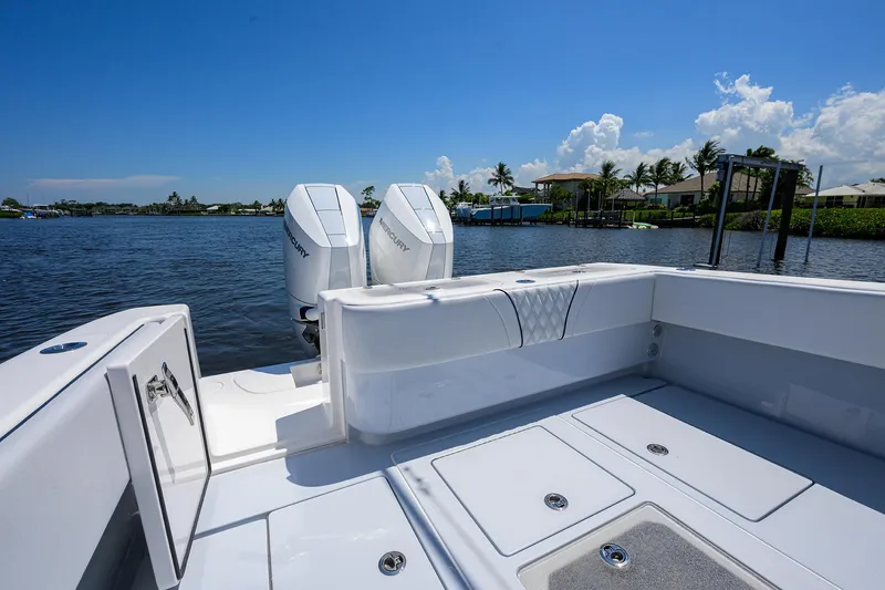 Slide: The Image of 2025 Contender 35 ST boat with dual Mercury engines on a sunny day. - 35