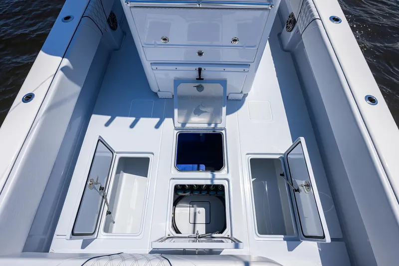 Slide: The Image of 2025 Contender 35 ST boat deck with open storage compartments and clean design. - 36