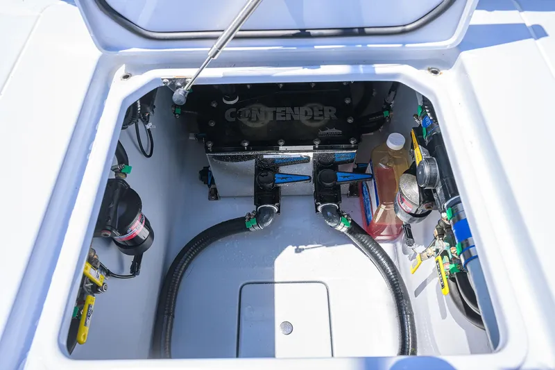 Slide: The Image of 2025 Contender 35 ST boat compartment with mechanical components and storage. - 40