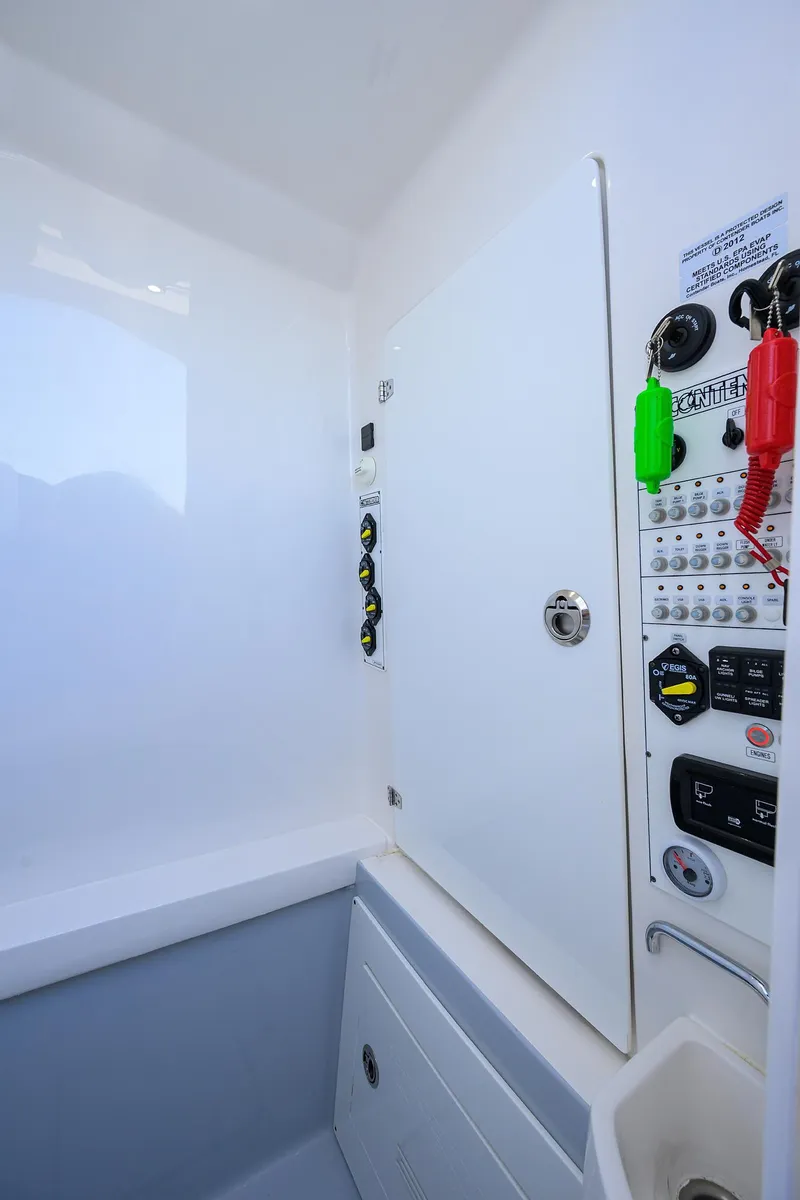 Slide: The Image of 2025 Contender 35 ST boat control panel with switches and safety features. - 44