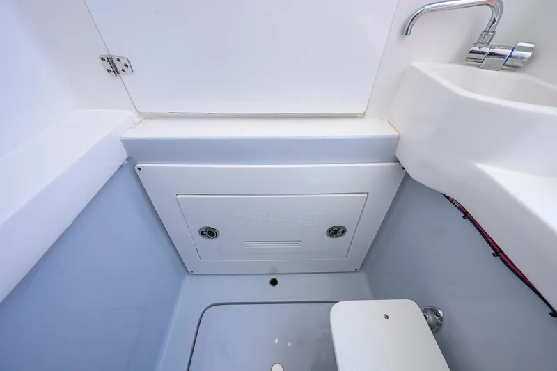 Slide: The Image of Interior of 2025 Contender 35 ST boat featuring a compact sink and storage compartment. - 47