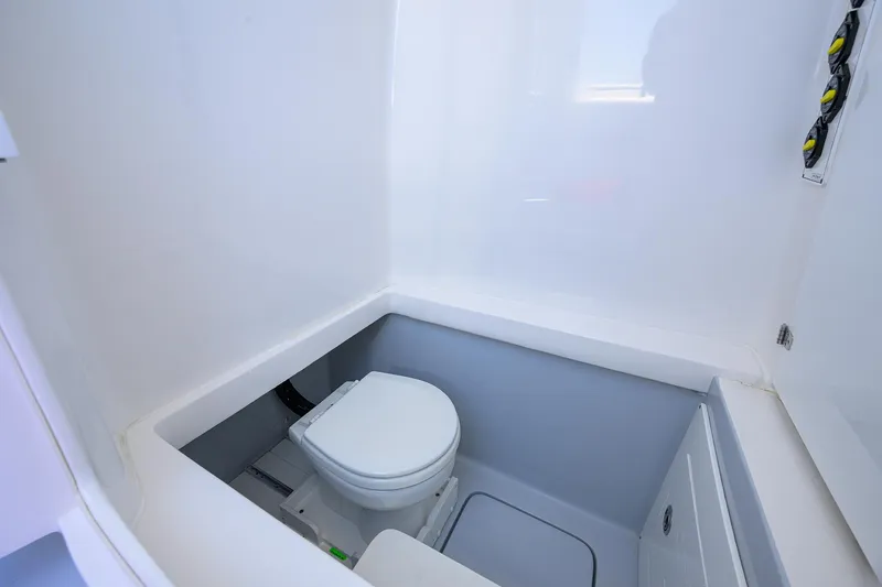 Slide: The Image of 2025 Contender 35 ST boat interior with compact marine toilet. - 49