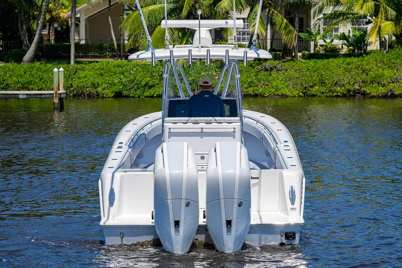 Slide: The Image of 2025 Contender 35 ST boat with dual engines on a calm waterway. - 6
