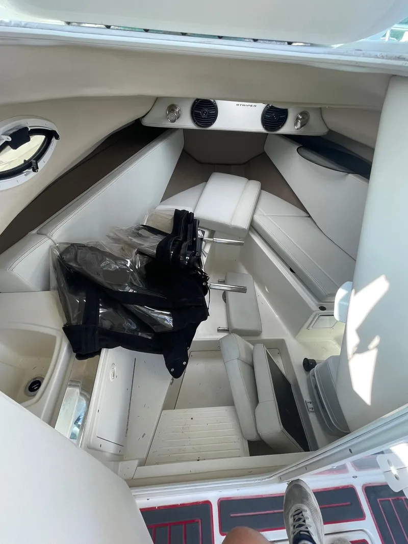 Slide: The Image of 2018 Striper 200 Walkaround cabin interior with white seating and storage. - 10