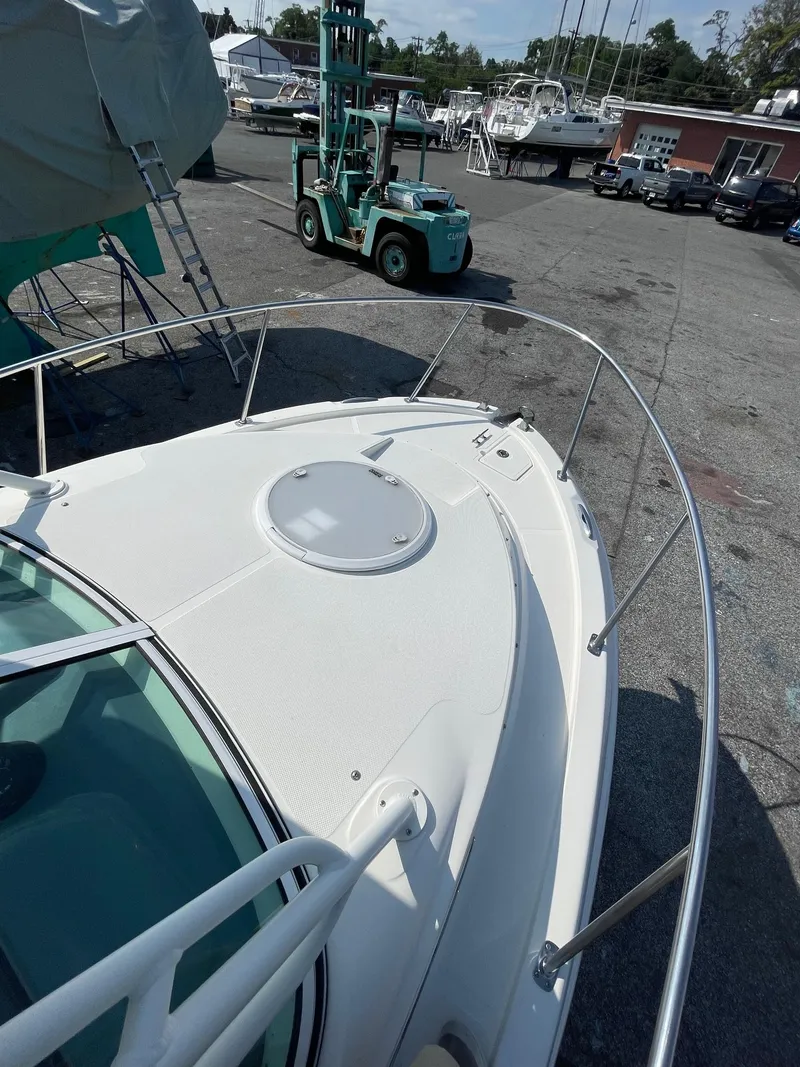 Slide: The Image of 2018 Striper 200 Walkaround boat on dock with forklift nearby. - 13