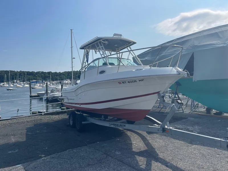 Slide: The Image of 2018 Striper 200 Walkaround boat on trailer at marina. - 14