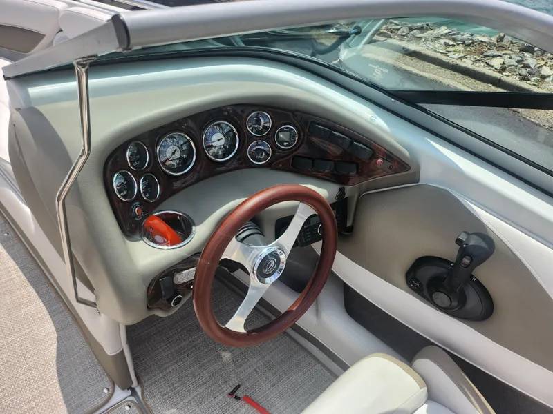 Slide: The Image of 2014 Crownline 21 SS boat dashboard with steering wheel and gauges. - 13