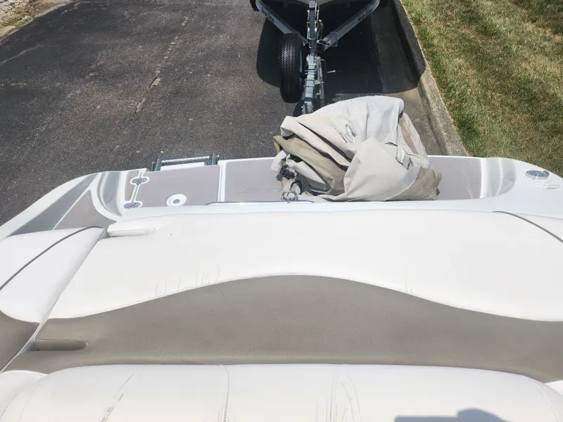 Slide: The Image of 2014 Crownline 21 SS boat interior with beige and white seating. - 21