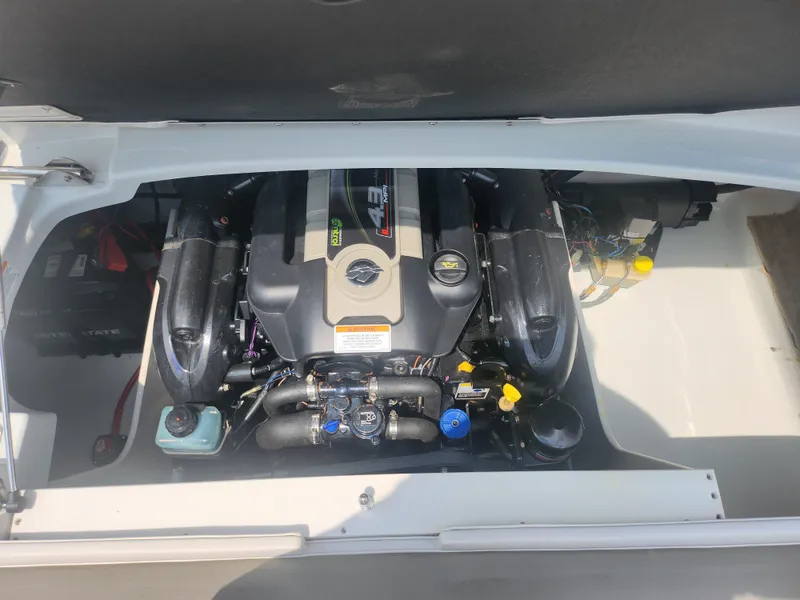 Slide: The Image of 2014 Crownline 21 SS boat engine compartment with open hatch. - 22