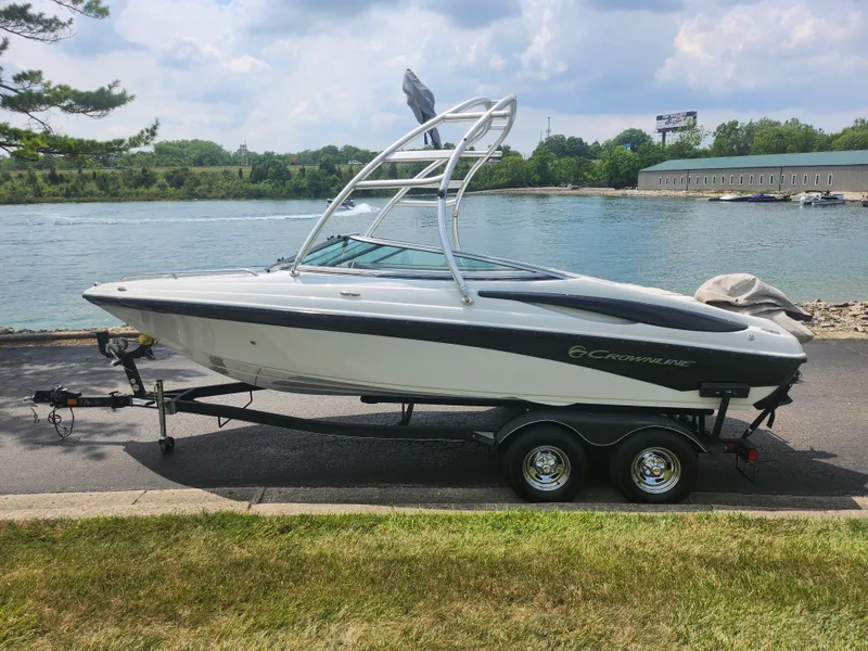 Slide: The Image of 2014 Crownline 21 SS boat on trailer by a lake. - 9