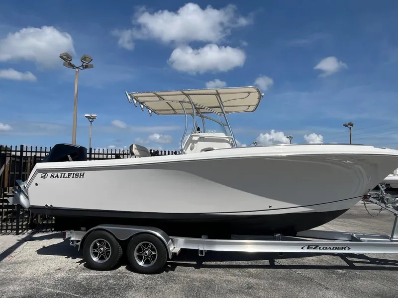 The Image of 2022 Sailfish 242 CC boat on trailer under clear blue sky. - 0