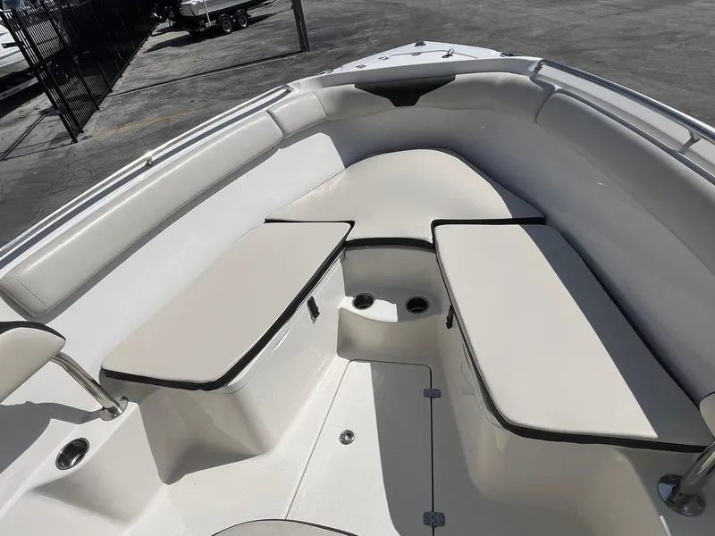 Slide: The Image of 2022 Sailfish 242 CC boat interior with cushioned seating and storage compartments. - 10