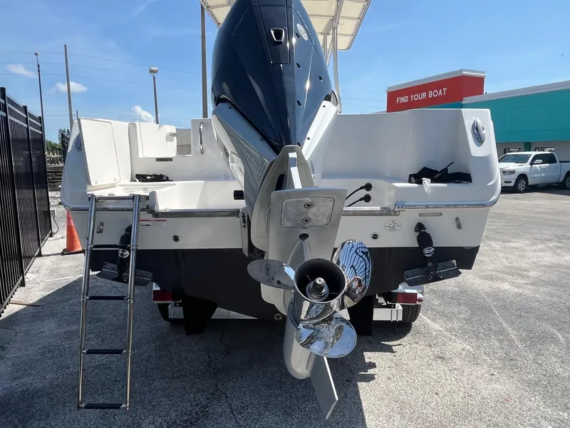 Slide: The Image of 2022 Sailfish 242 CC boat rear view with outboard motor and ladder. - 4