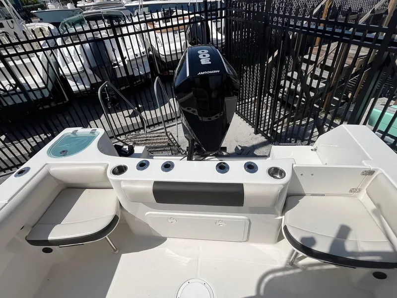 Slide: The Image of 2022 Sailfish 242 CC boat interior with seating and Mercury outboard engine. - 6