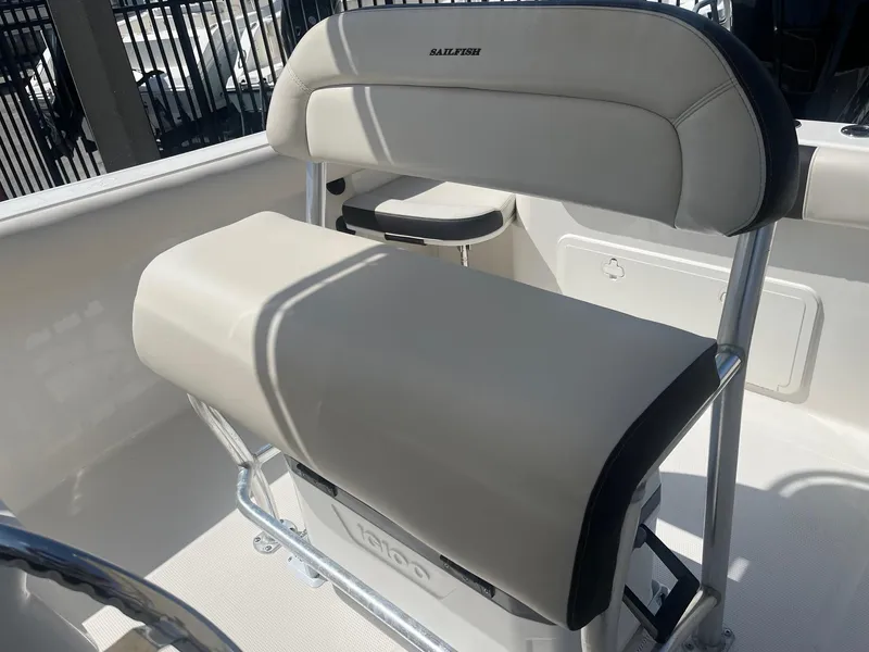 Slide: The Image of 2022 Sailfish 242 CC boat seat with beige upholstery and metal frame. - 7