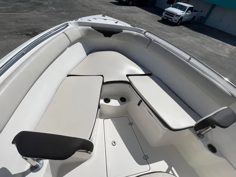 Slide: The Image of 2022 Sailfish 242 CC boat interior with cushioned seating and storage compartments. - 9
