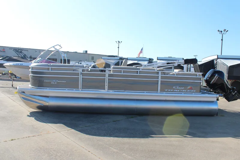 The Image of 2025 Sun Tracker Party Barge 22 RF DLX pontoon boat in a marina setting. - 0