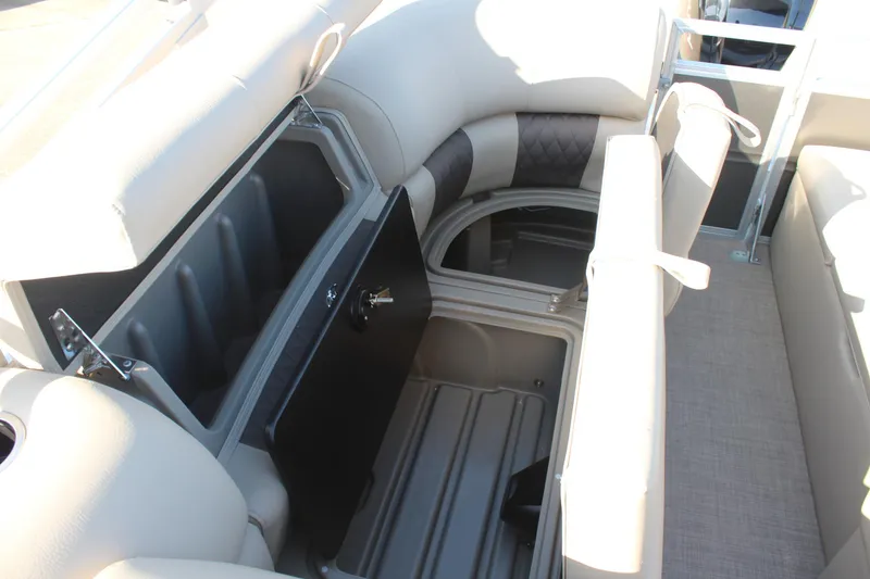 Slide: The Image of 2025 Sun Tracker Party Barge 22 RF DLX interior storage compartment with open seat. - 10