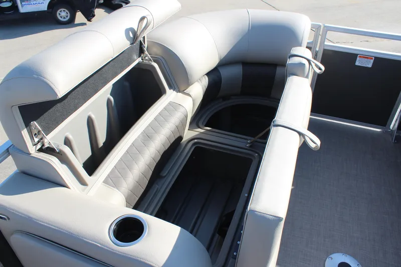 Slide: The Image of 2025 Sun Tracker Party Barge 22 RF DLX with open storage compartments and cup holder. - 16