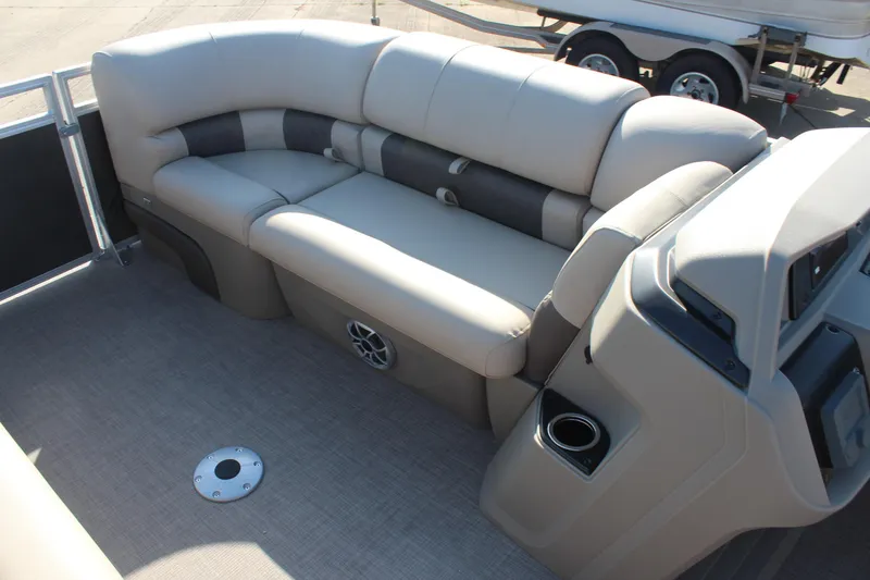Slide: The Image of 2025 Sun Tracker Party Barge 22 RF DLX interior with plush seating and cup holder. - 19
