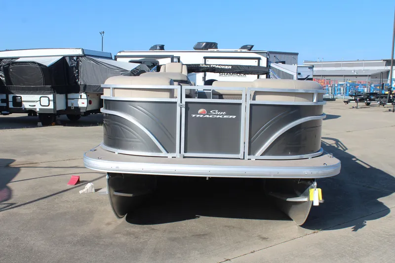 Slide: The Image of 2025 Sun Tracker Party Barge 22 RF DLX pontoon boat in a parking lot. - 2