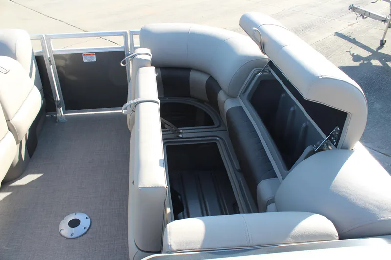 Slide: The Image of 2025 Sun Tracker Party Barge 22 RF DLX with open storage compartments and cushioned seating. - 21