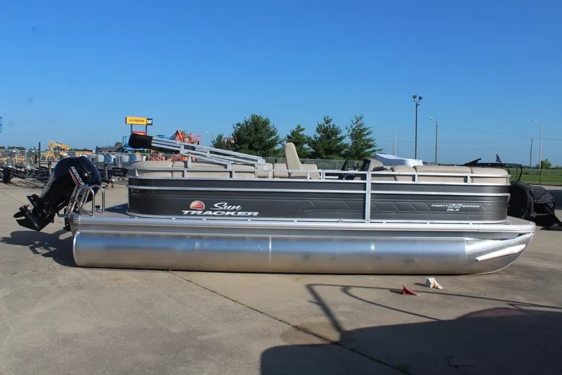 Slide: The Image of 2025 Sun Tracker Party Barge 22 RF DLX pontoon boat on display outdoors. - 4