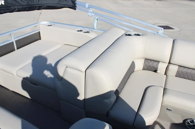 Slide: The Image of 2025 Sun Tracker Party Barge 22 RF DLX with beige seating and cup holders. - 9