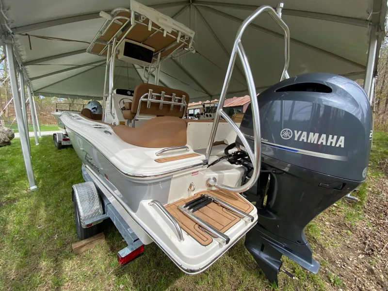 Slide: The Image of 2026 Pioneer 202 Islander boat with Yamaha engine on trailer under canopy. - 12