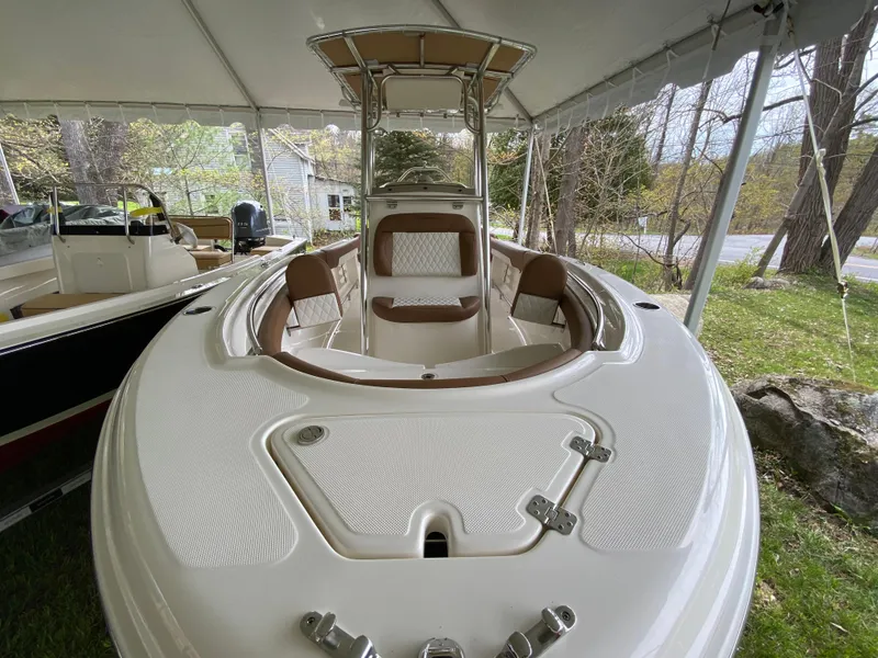 Slide: The Image of 2026 Pioneer 202 Islander boat under canopy, featuring spacious seating and modern design. - 16