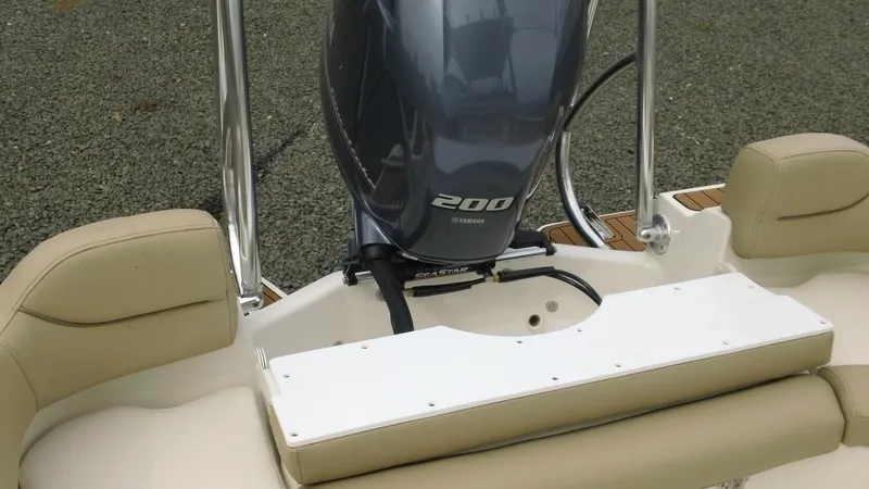 Slide: The Image of 2026 Pioneer 202 Islander boat with Yamaha 200 engine, beige seating, and stainless steel rails. - 17