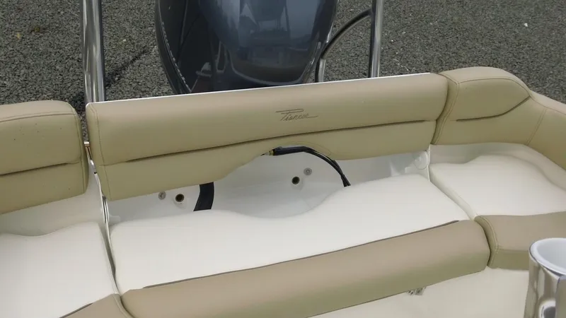 Slide: The Image of 2026 Pioneer 202 Islander boat interior with beige and white cushioned seating. - 18