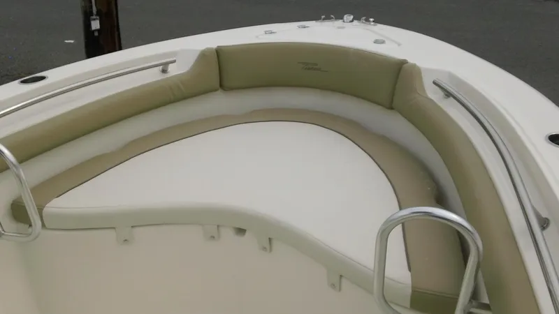 Slide: The Image of 2026 Pioneer 202 Islander boat interior with cushioned seating and stainless steel railings. - 20