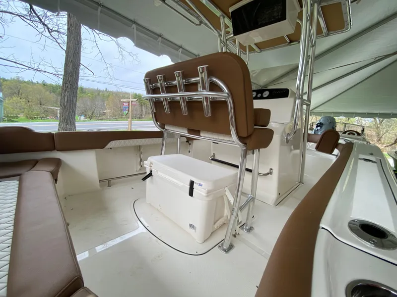 Slide: The Image of 2026 Pioneer 202 Islander boat interior with seating, cooler, and console under canopy. - 3