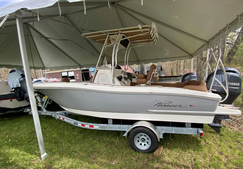 Slide: The Image of 2026 Pioneer 202 Islander boat on trailer under tent, featuring Yamaha engines. - 4
