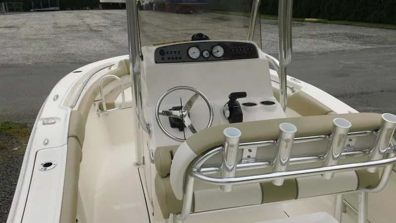 Slide: The Image of 2026 Pioneer 202 Islander boat interior with steering console and rod holders. - 6