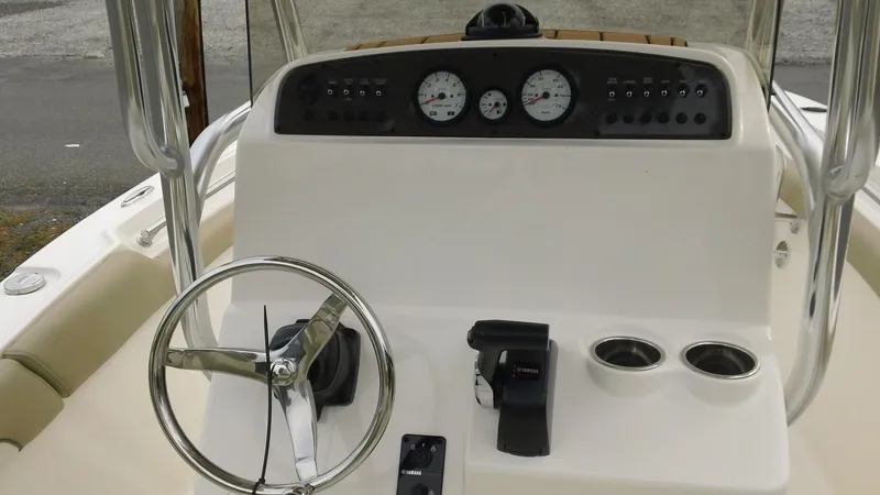 Slide: The Image of 2026 Pioneer 202 Islander boat dashboard with steering wheel and control panel. - 8