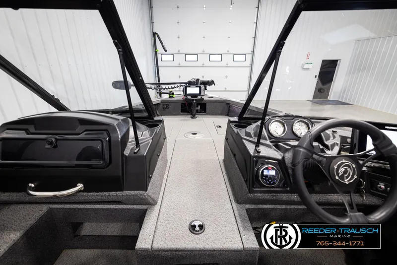 Slide: The Image of 2022 Crestliner 1850 FISHHAWK boat interior with steering wheel and dashboard controls. - 20