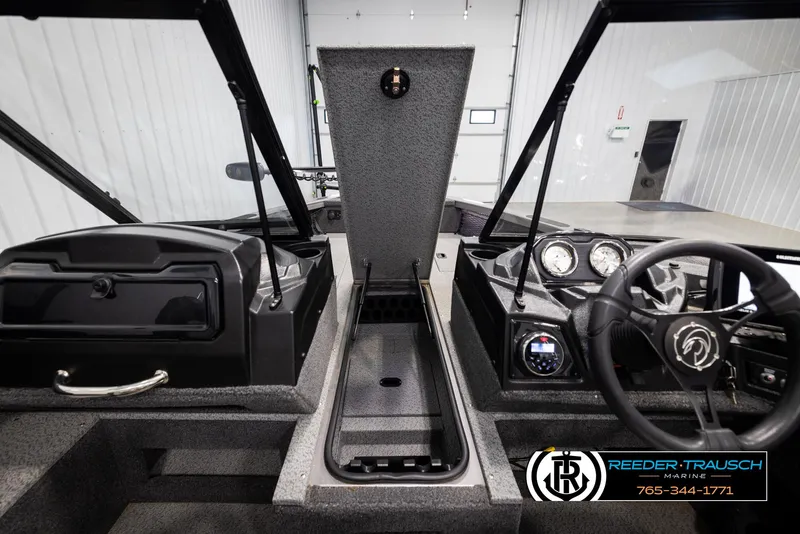 Slide: The Image of 2022 Crestliner 1850 FISHHAWK boat interior with open storage and dashboard controls. - 21