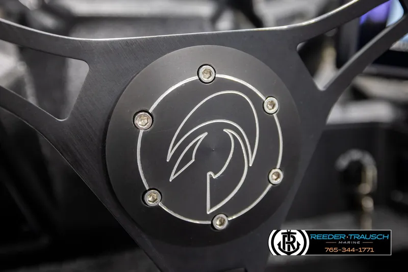 Slide: The Image of Steering wheel detail of 2022 Crestliner 1850 FISHHAWK boat, featuring sleek design and logo. - 29