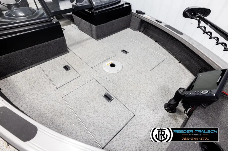 Slide: The Image of 2022 Crestliner 1850 FISHHAWK boat interior with storage compartments and navigation equipment. - 8