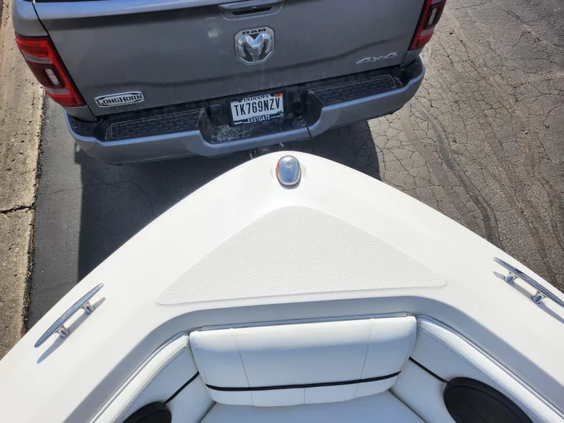 Slide: The Image of Bow of 2014 Sea Ray 210 SLX near a parked truck on a street. - 17