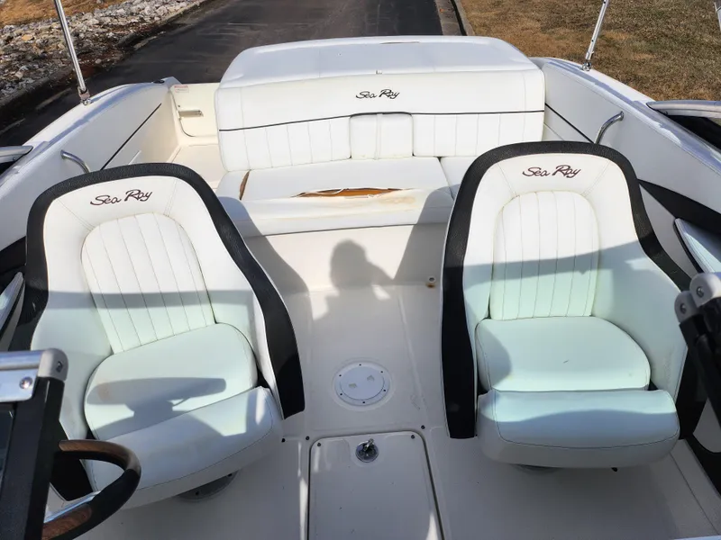 Slide: The Image of 2014 Sea Ray 210 SLX boat interior with white seating and black trim. - 20