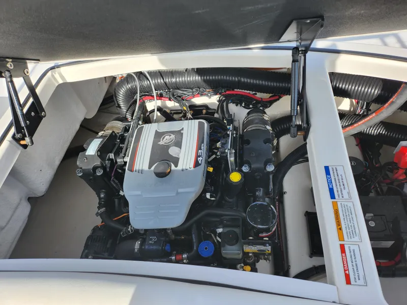 Slide: The Image of Engine compartment of a 2014 Sea Ray 210 SLX boat, showcasing the motor and components. - 22