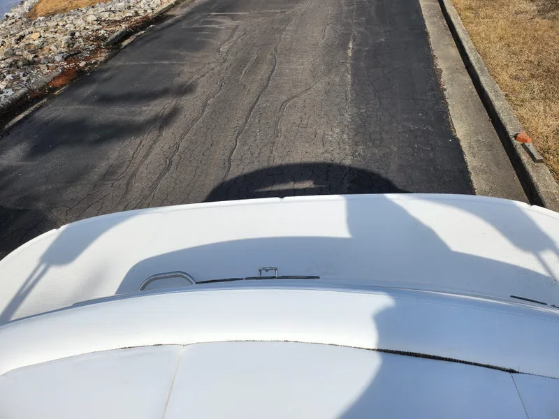 Slide: The Image of 2014 Sea Ray 210 SLX boat on a paved road, top view. - 23