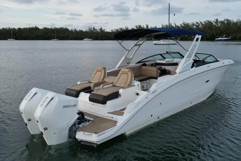 The Image of 2021 Sea Ray SDX 290 Outboard boat on calm water, featuring twin Mercury engines. - 1