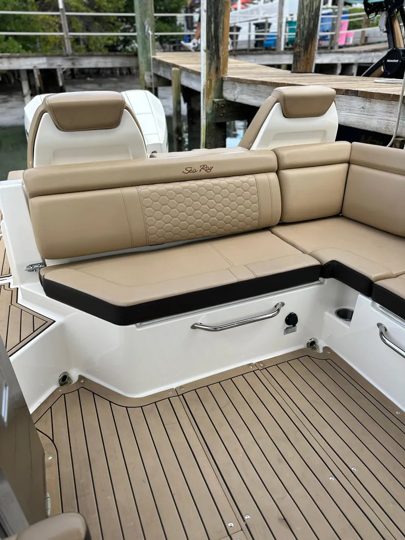 Slide: The Image of 2021 Sea Ray SDX 290 Outboard boat with tan leather seating and teak flooring. - 12