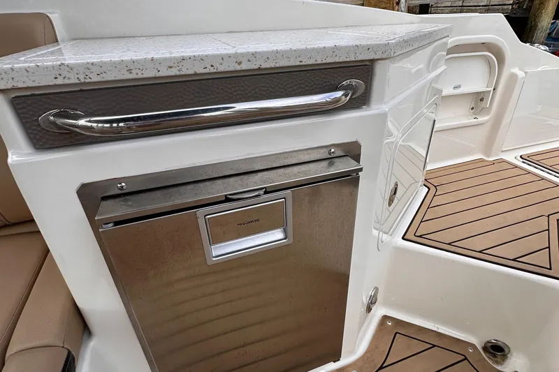 Slide: The Image of 2021 Sea Ray SDX 290 Outboard boat interior with Dometic fridge and stylish countertop. - 15