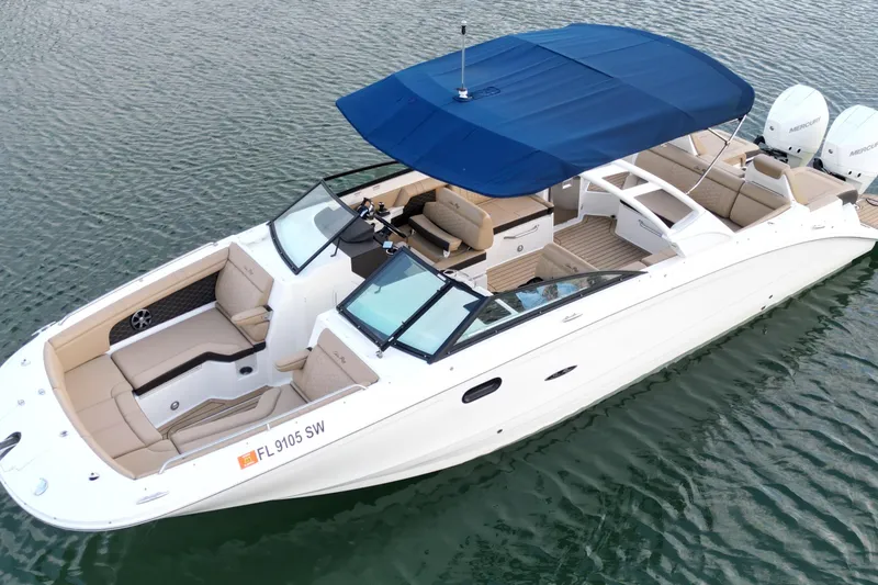 Slide: The Image of 2021 Sea Ray SDX 290 Outboard boat with blue canopy on water. - 3