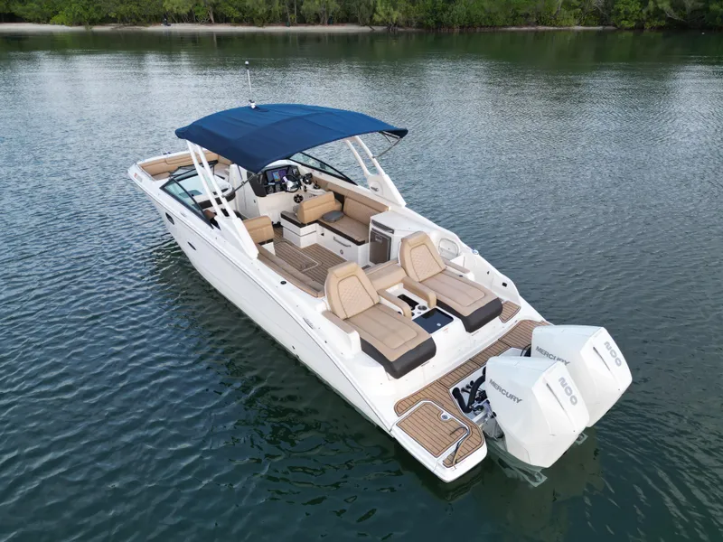 Slide: The Image of 2021 Sea Ray SDX 290 Outboard boat on calm water, featuring spacious seating and dual engines. - 5